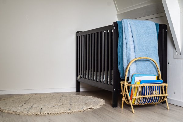 a convertible crib in a corner of the babies room